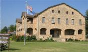 Front of the library with the US flag in front blowing in the wind